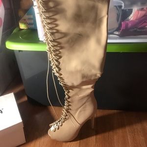 Thigh high heeled lace up boots
